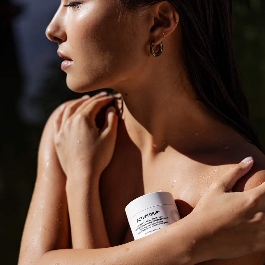 Model holding Active Drip Iconic Moisturiser jar